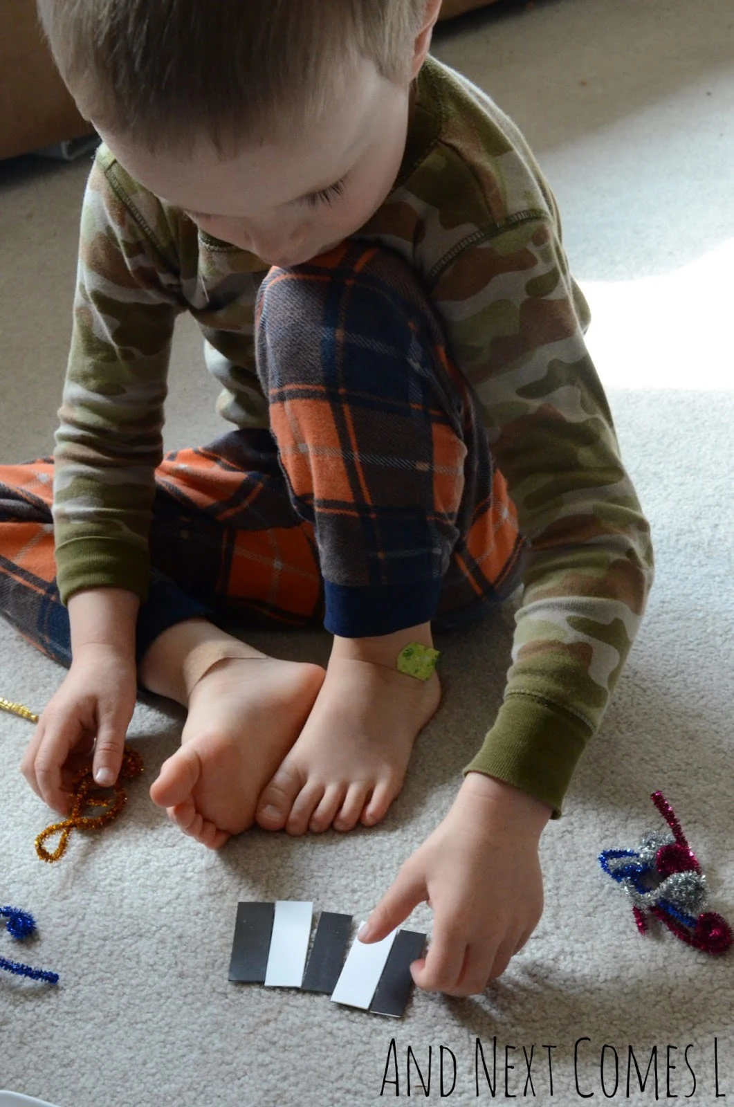 J playing with magnetic piano keys from And Next Comes L