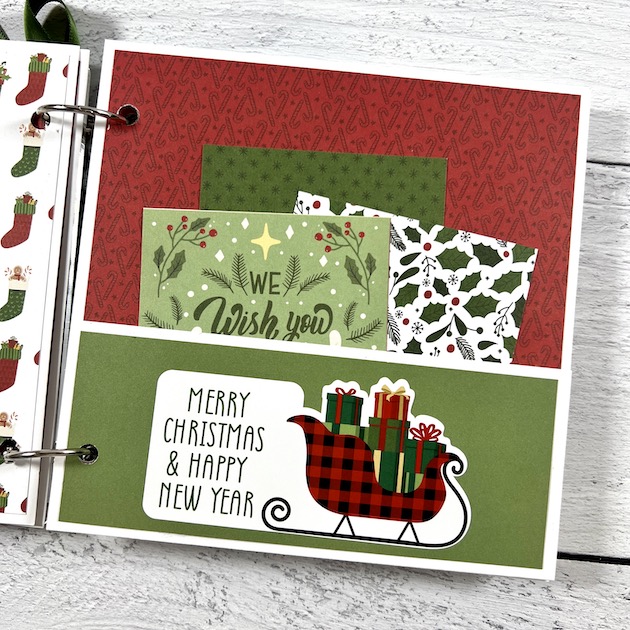 Christmas Scrapbook Album Page with a pocket, sleigh, and presents