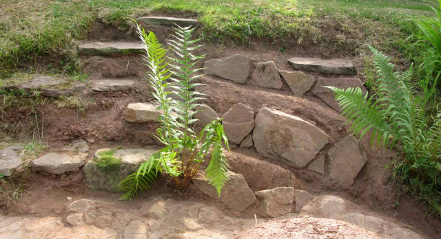 The rockery and herb garden at the back of the earth oven.