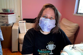 white woman with a purple fabric mask