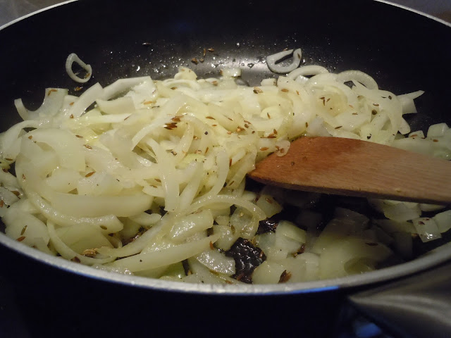 Frying onions and cumin.