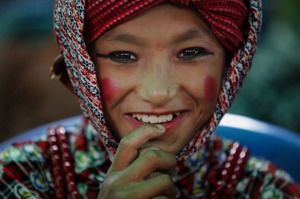 70 Of The Most Touching Photos Taken In 2015 - A Nepalese boy gets ready to perform a dance during a rally held to pay tribute to the victims of the April and May earthquakes, which killed 8,800 people.