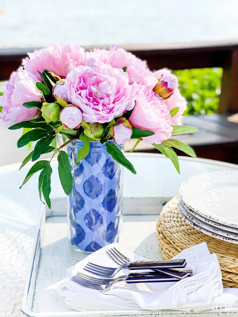 blue white glass vase pink peonies table silverware