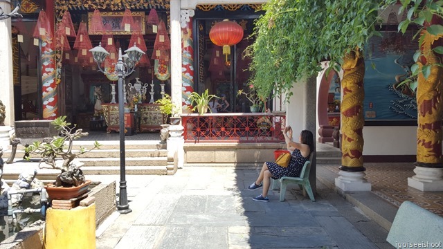 Pillars with encircling golden dragons on one side of the courtyard. Quang Trieu (Canton) Assembly Hall in Hoi An ancient town 