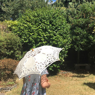 Keeping our autistic kids cool - a girl holding parasol