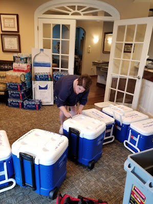 Cindy in the Apex Dental Group reception area labeling coolers