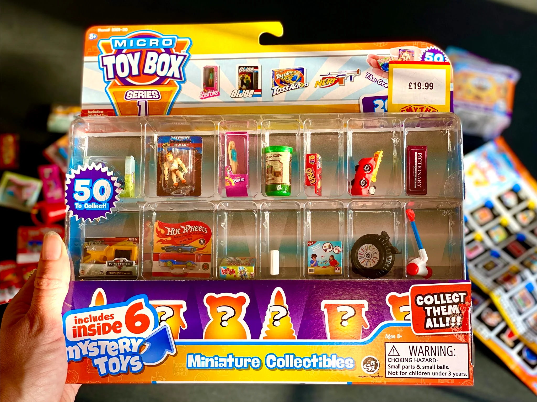 A 20 pack of Micro Toy Box collectibles being held