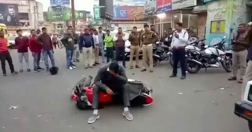 Watch: Man frustrated by a traffic challan throws his motorcycle around, ending up in tears