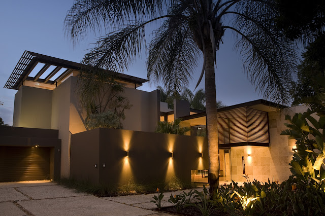 Picture of the house with lights turned on on the facade