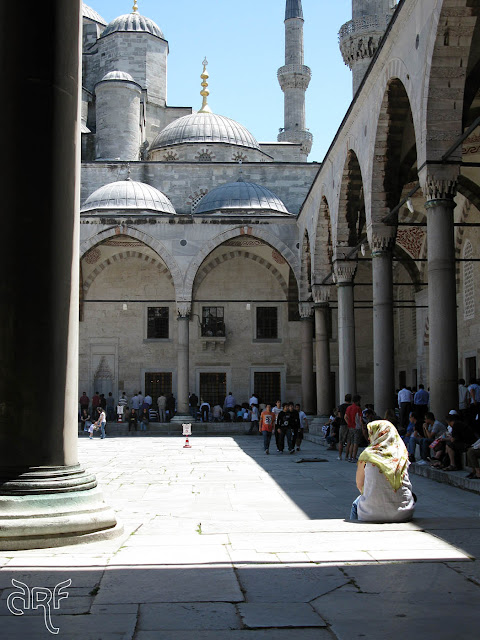 woman sitting in square of mosque, Istanbul