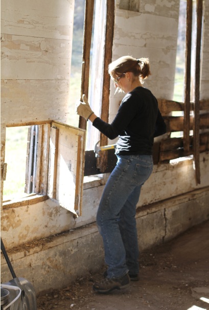 Allison removes boards guarding the broken windows