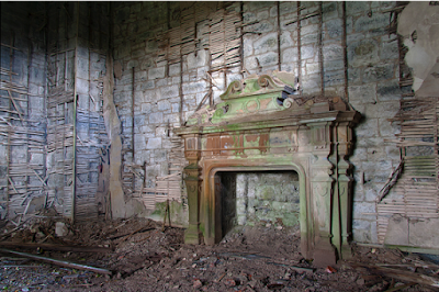 Grand fireplace surrounded by rubble