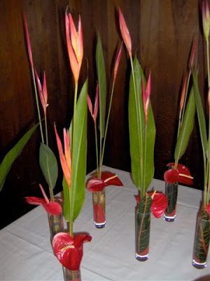 This was a tropical theme wedding with simple centerpieces of Heleconias 