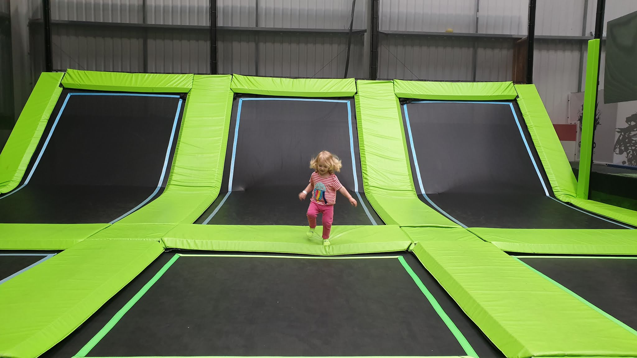 toddler running to a trampoline