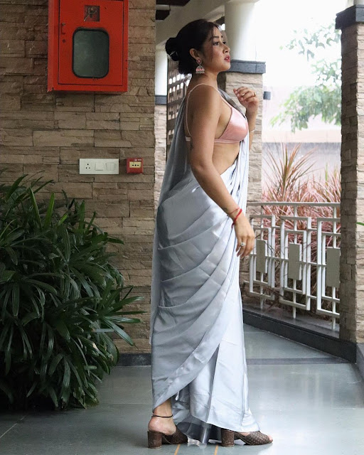 Sofia Ansari in a silver satin saree and pink backless bikini blouse. Instagram influencer sexy in a sari