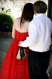 Prom Couple holding shoes