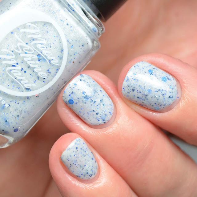grey crelly nail polish with blue glitter swatch