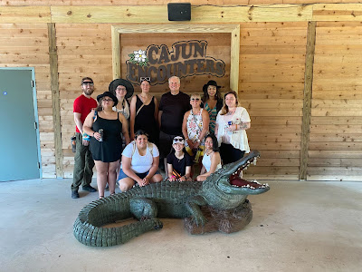 Group standing in front of Cajun Encounters sign. Credit: Jenny Huynh.