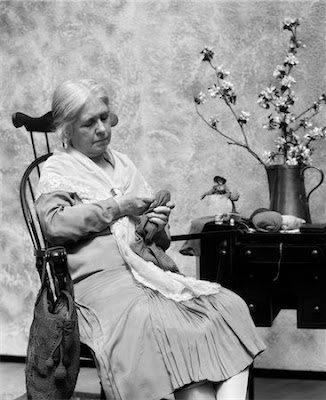 1920s-elderly-woman-sitting-in-rocking-chair-darning Photographer H.ARMSTRONG ROBERTS