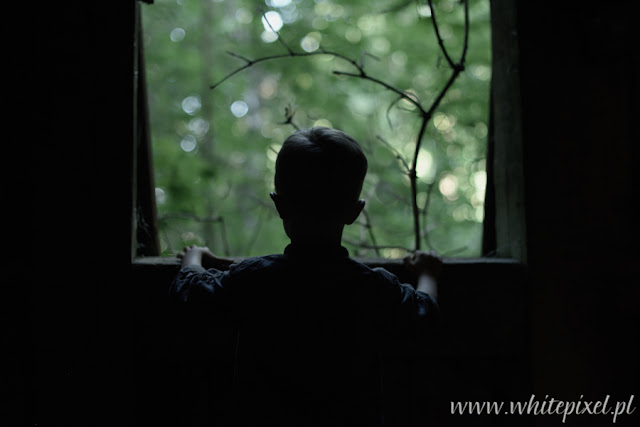 W starej kamienicy pod Warszawą smutny chłopiec wygląda przez stare okno