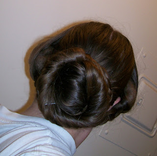 French twist coiffure with side bands braids, c. 1854.