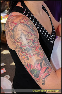 Human Face Tattoo on Woman Arm