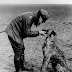 Manfred von Richthofen “The Red Baron” petting his dog on an airfield, 1916