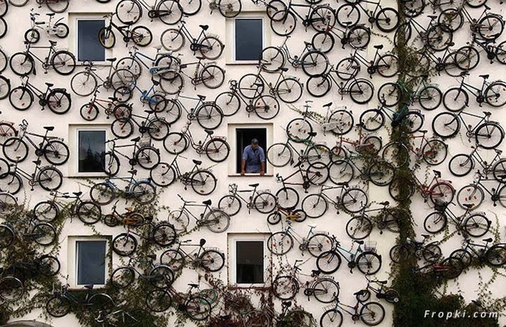 A funny man expose the 120 bicycles at his walls