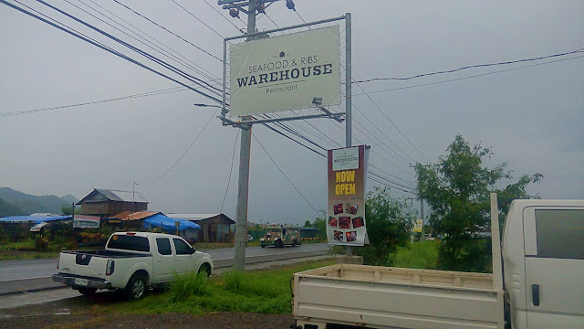 view of roadside signboard of Seafood & Ribs Warehouse Restaurant in Palo Leyte