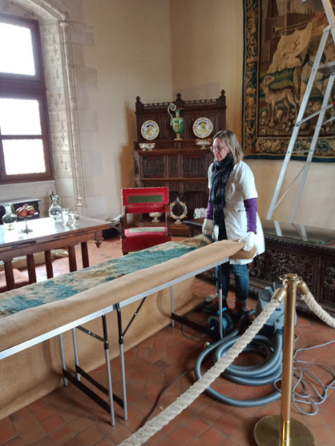 Conservation vacuum cleaning a tapestry at the Chateau Royal d'Amboise, Indre et Loire, France. Photo by Loire Valley Time Travel.