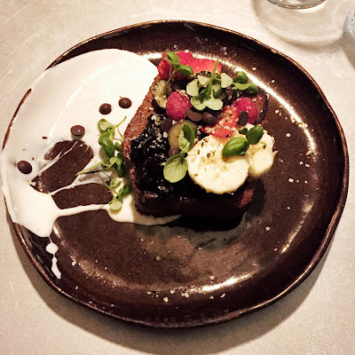 A dessert of chocolate brownie, berries and coconut yoghurt at Dr Legumes