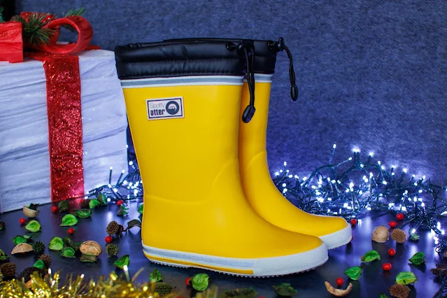 Yellow wellies with Spotty Otter logo and a black section at the top with a toggle to help stop the rain getting in