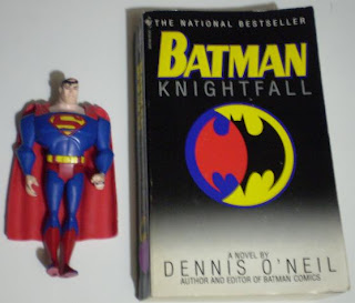 Superman action figure and Batman: Knightfall paperback book