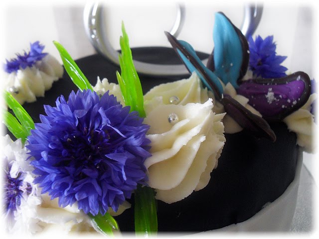 Detailed close up of the wedding cake topper purple cornflower and 