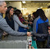 Barack Obama and his family pictured distributing food to people to celebrate Thanksgiving