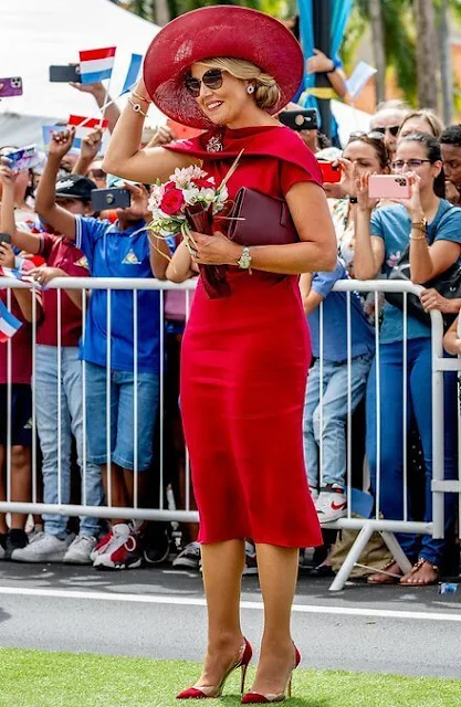 Queen Maxima in Natan Jenny silk crepe dress. Princess Amalia wore a pinstriped cotton and linen blazer suit by Max Mara