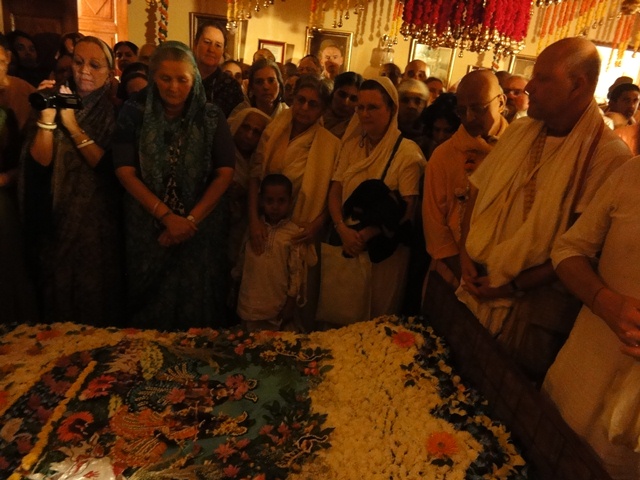 Devotees Mournfully Gather at the Bed from which Srila Prabhupada Departed in 1977.