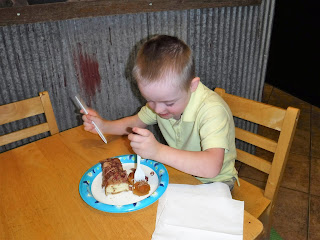 boy eating donut at child sized table and chairs at FlyBoy Donuts in Sioux Falls, South Dakota