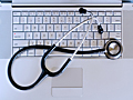 stethoscope over a Macintosh laptop