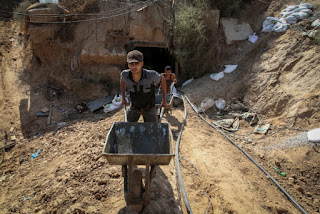 Palestinian Men work at tunnel entrance