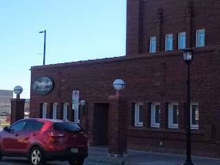 historic bank building silhouetted against a bright blue sky