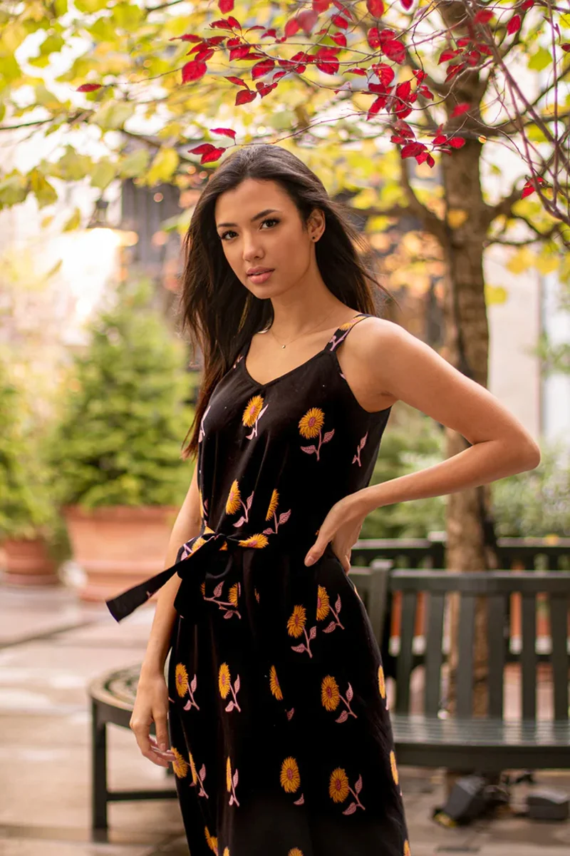 beautiful young woman in a witchy outfit is posing for the camera