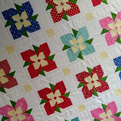 patchwork quilt top with flower blocks