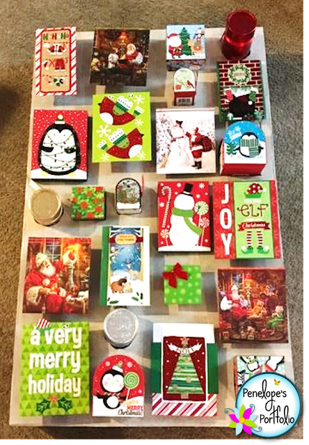 Holiday greeting cards, gift bags, and gift boxes are used to create this life-size advent calendar