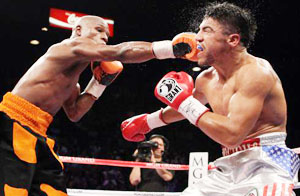 Floyd Mayweather Jr. connects with a right to the face of Victor Ortiz during their WBC welterweight title fight in Las Vegas.