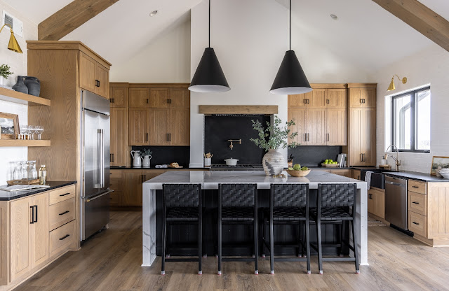 Large kitchen with wood cabinets an marble island.