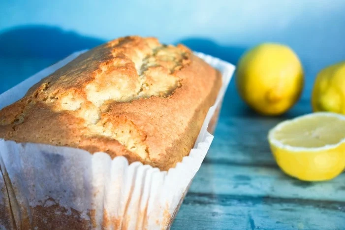 Lemon cake in a loaf tin liner before it is iced