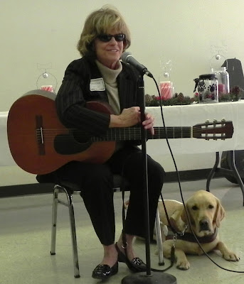 woman with guitar and yellow Lab