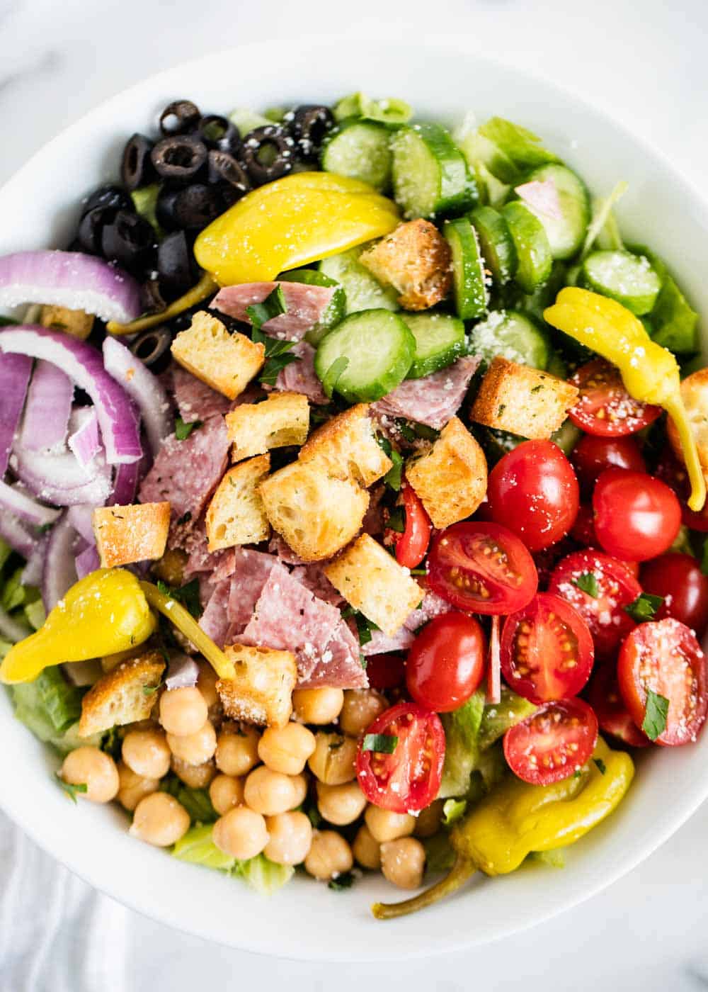 Quick and easy Italian chopped salad loaded with tons of fresh and flavorful ingredients. This big Italian salad makes the perfect lunch, dinner or side salad recipe.
