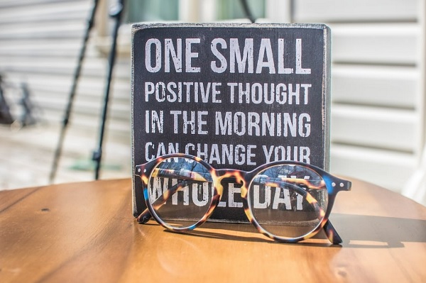 An image of spectacles and positive quote plaque